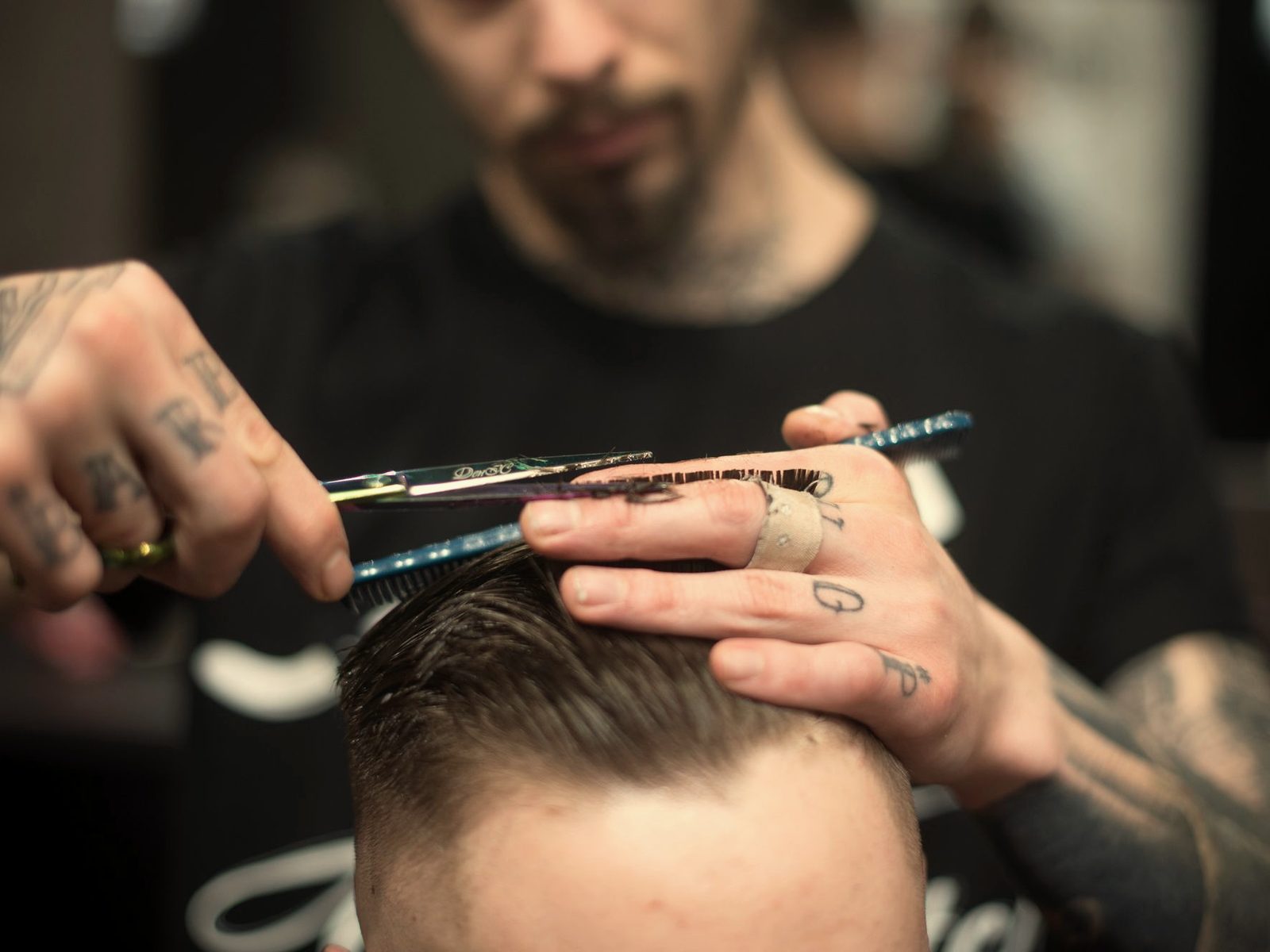 A barber cutting a man's hair