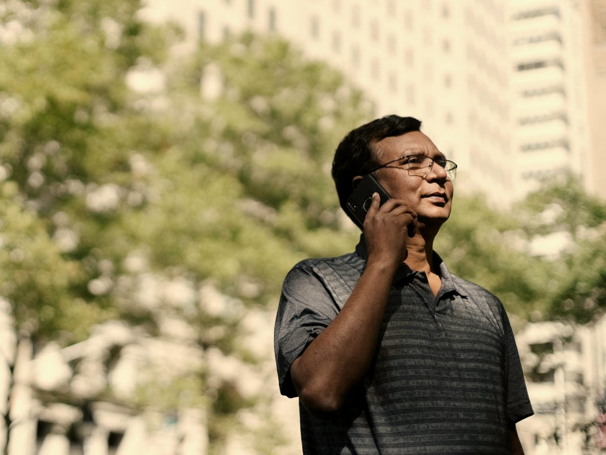 A man taking a phone call outside
