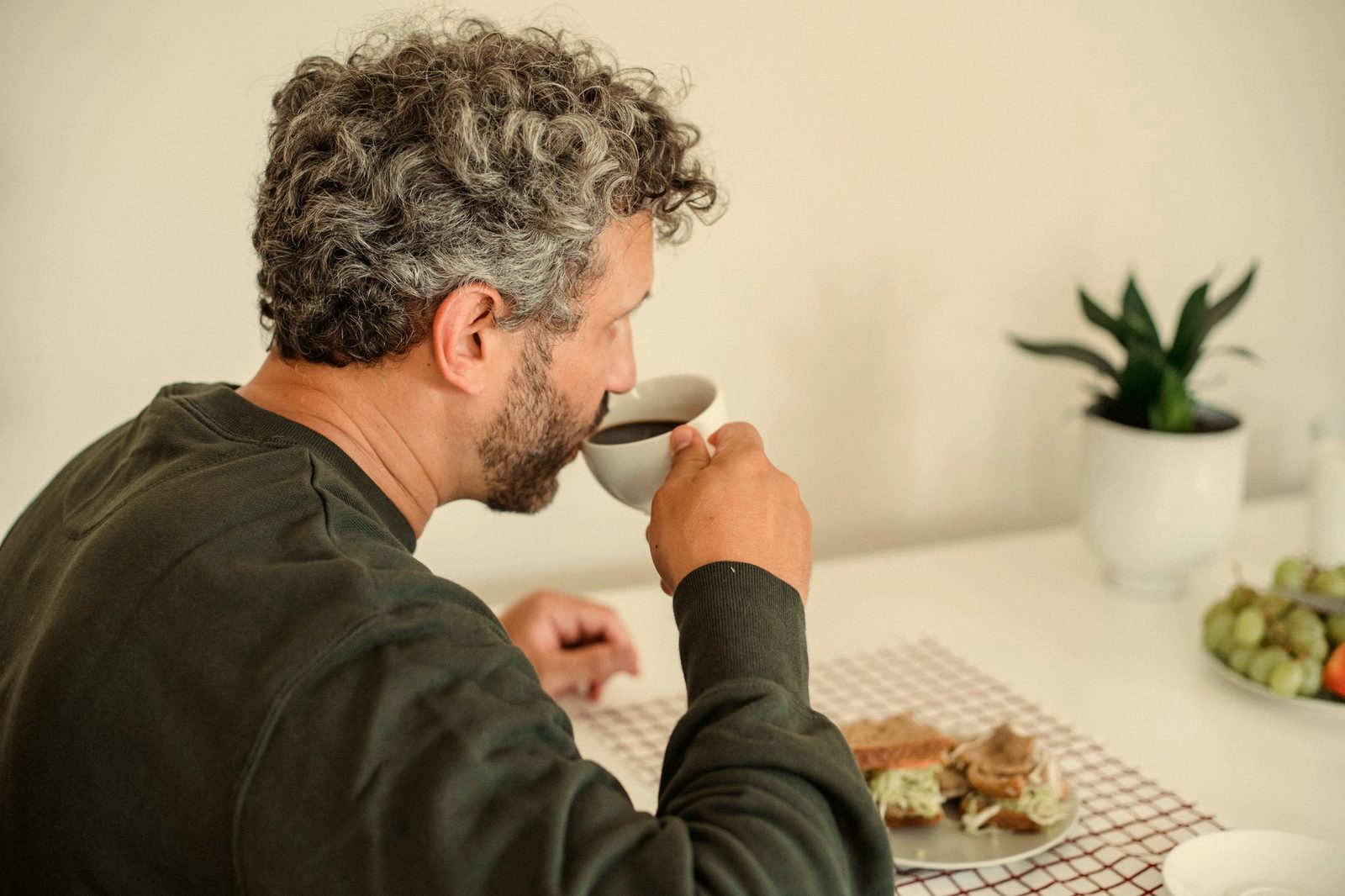 A man at his kitchen table in the morning